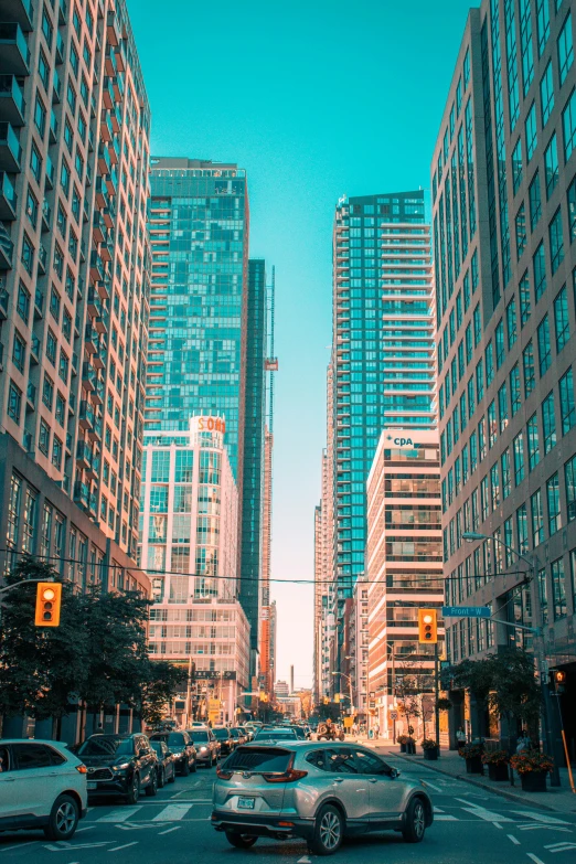 cars are driving in a large city at dusk