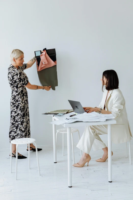 the lady is putting the bag on her pants