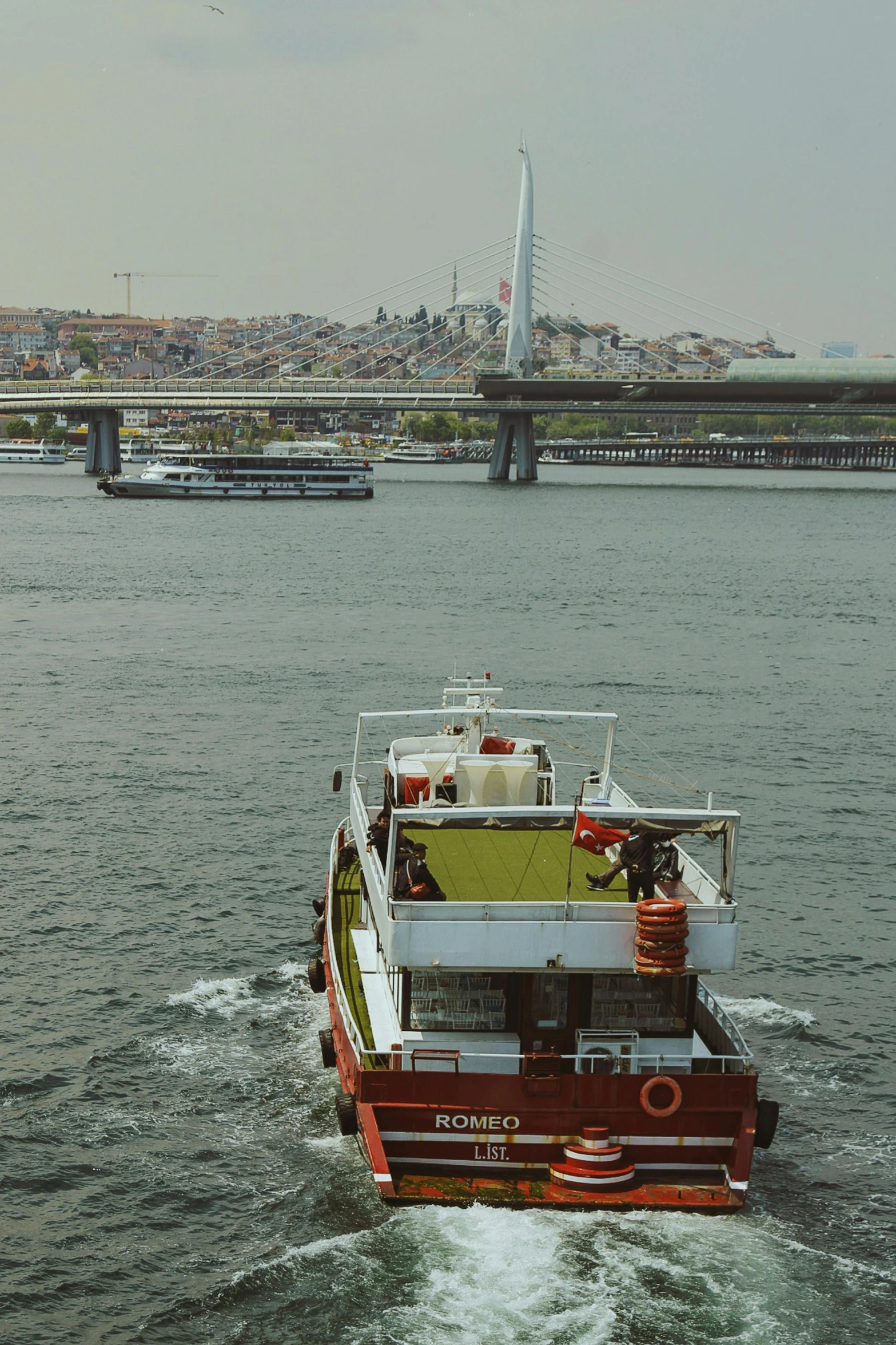 a boat moving along the river in front of a city