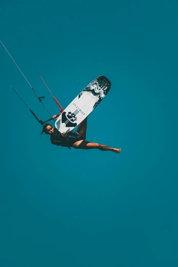a man is falling into the air while kitesurfing