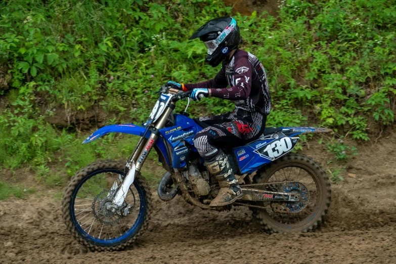 a man in full body gear is riding a motorcycle