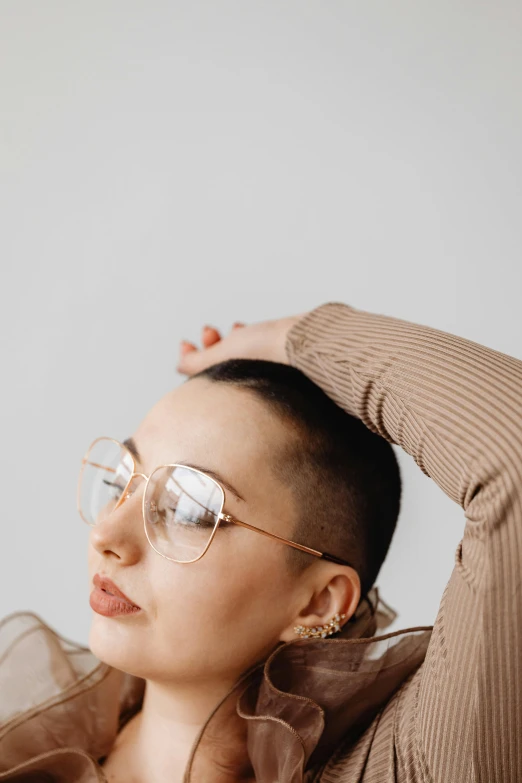 a woman in a brown top has sunglasses on her head