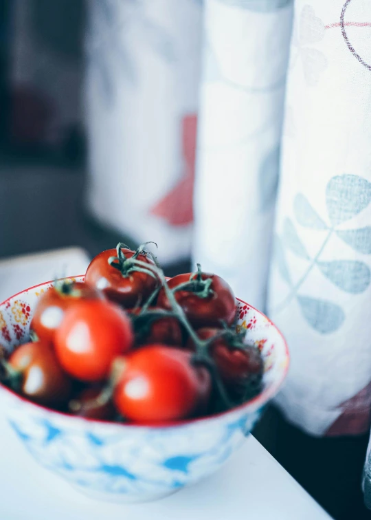 small bowl of tomatoes on the table by the sewing machine