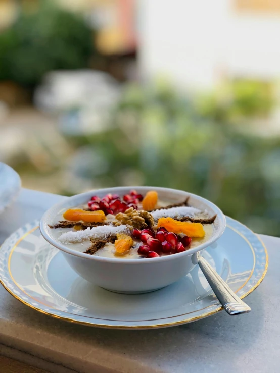 a bowl with berries, powdered sugar and spices sits on a table