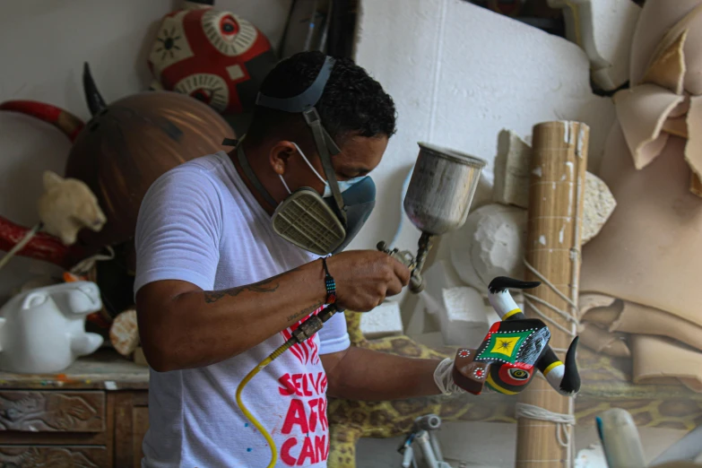 a man is using a paint roller in his crafts room