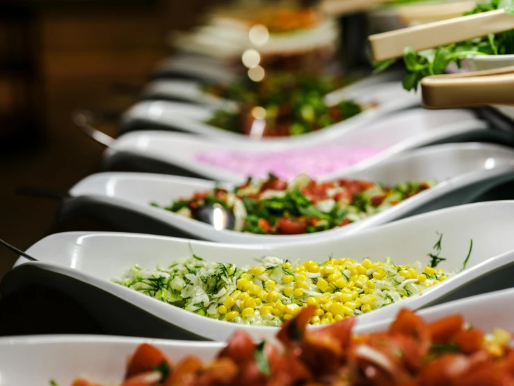 a row of bowls full of different types of food