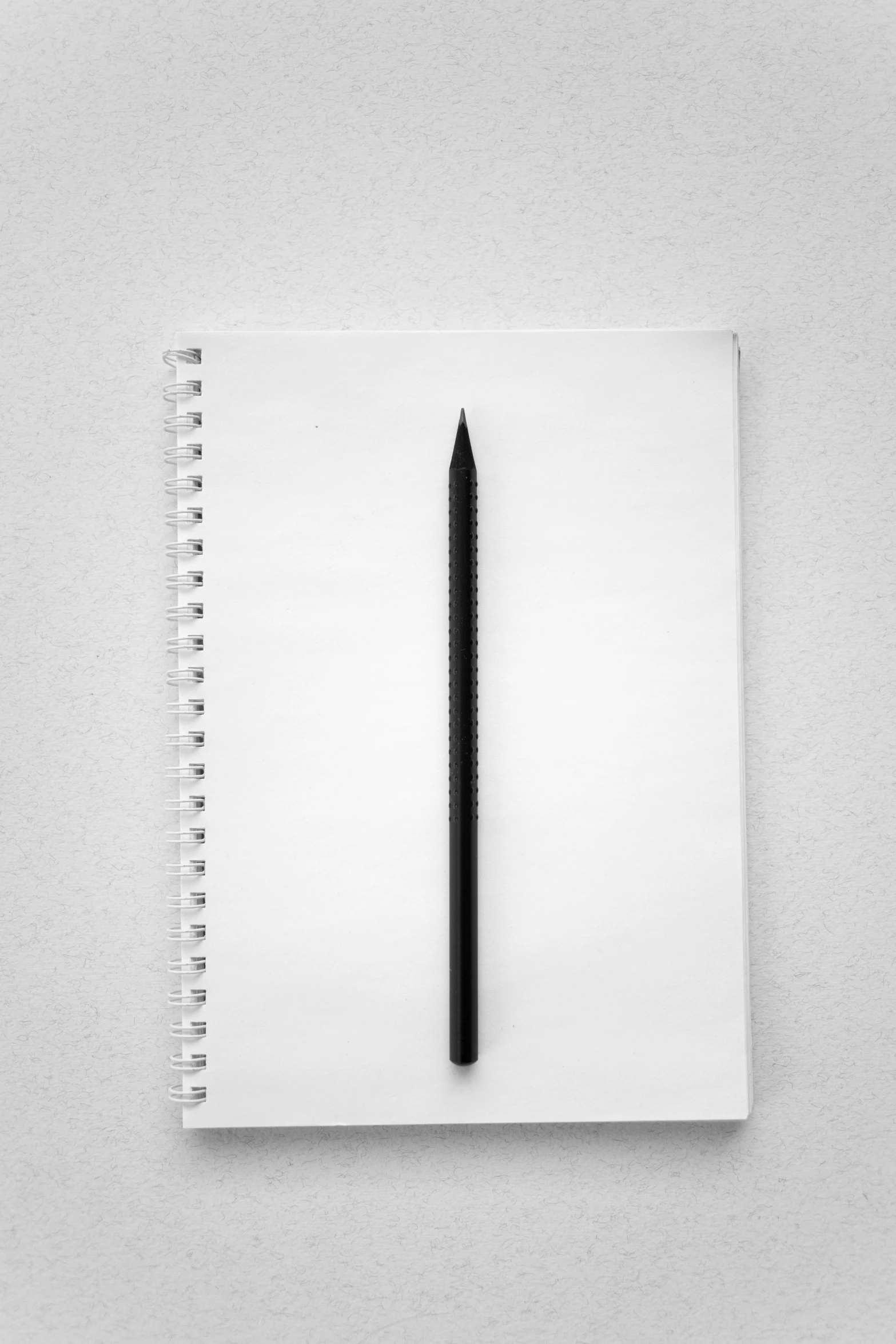 a notebook with a pen on the top and a blurry background