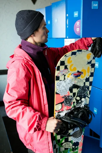 a man in a jacket holding a skateboard