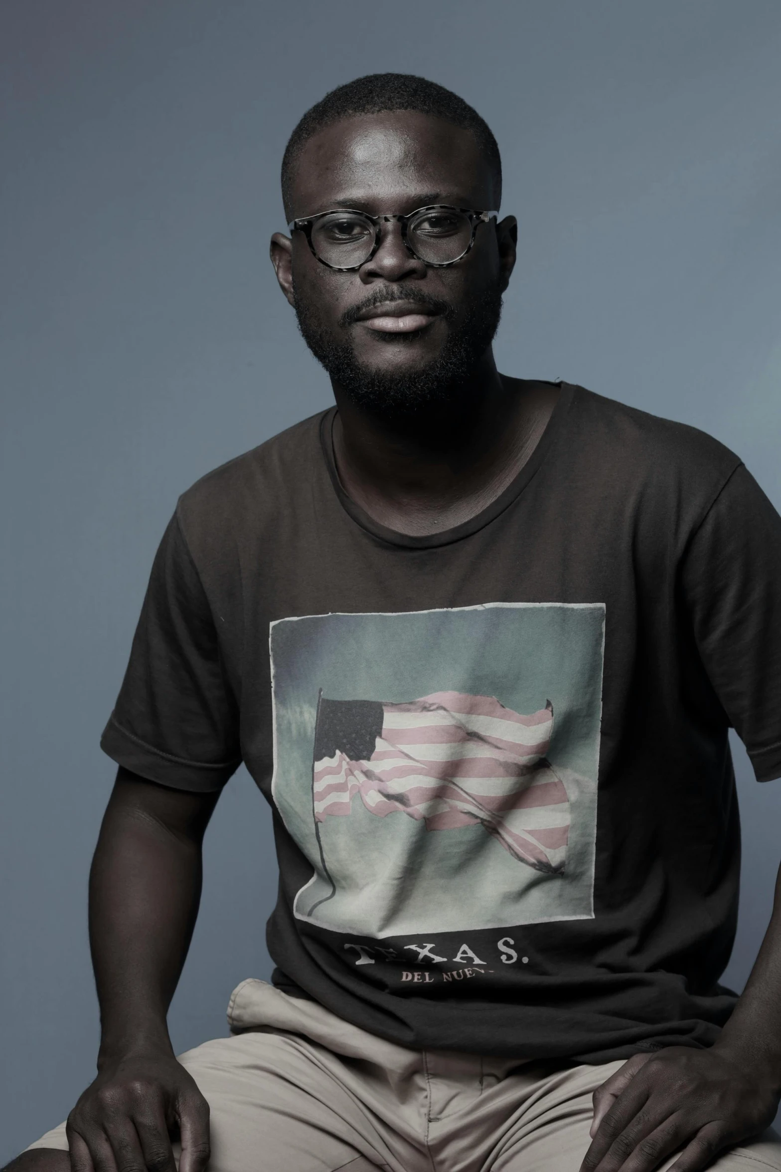 black man in glasses and an american flag tee shirt