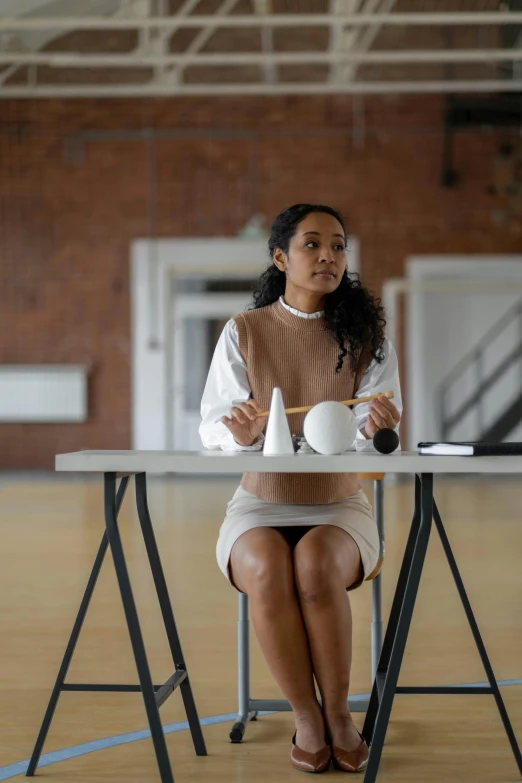 a person that is sitting at a table with a tea pot