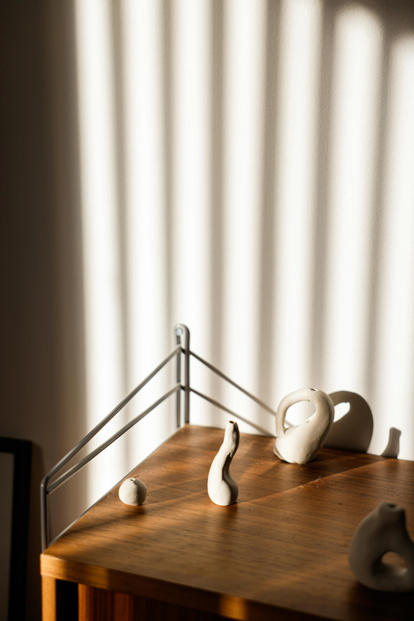 some small vases are on top of a wooden desk