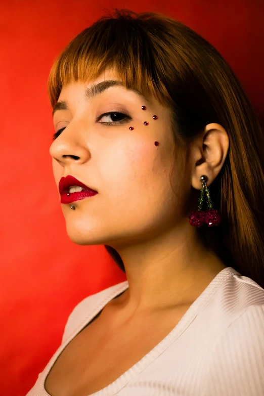 a young woman wearing large dangling earrings