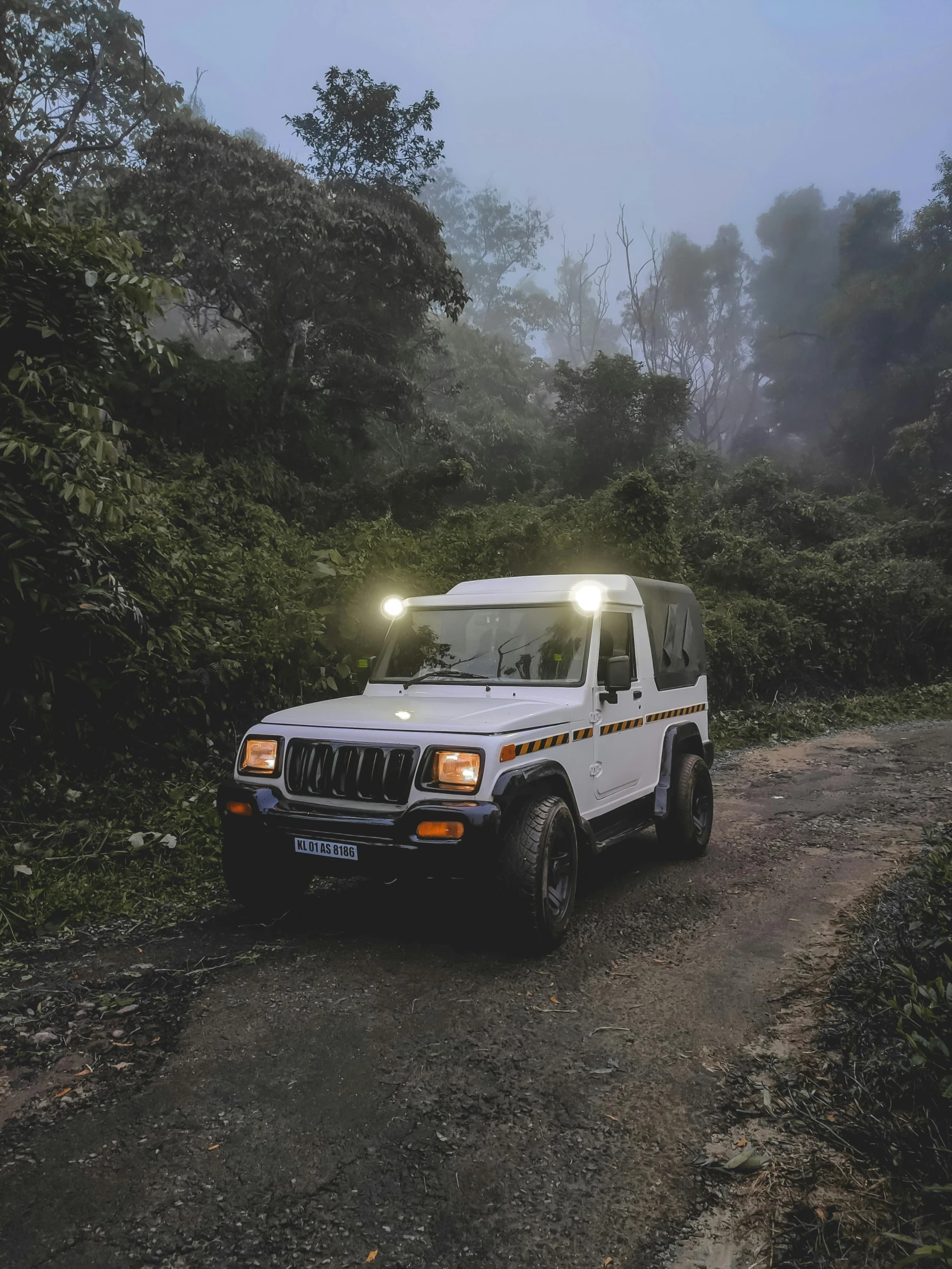 a white truck driving down a dirt road