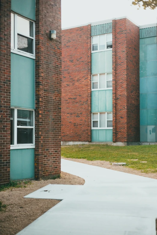 an apartment building on a grassy block in the city