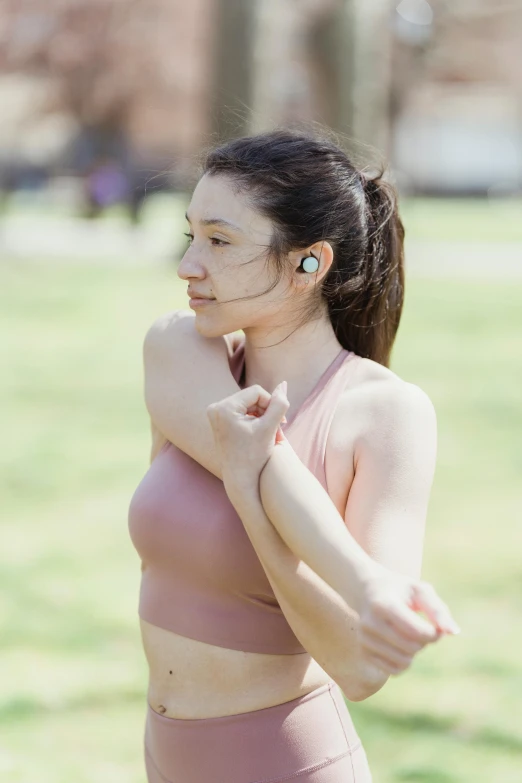 the woman in a pink bikini has ear buds