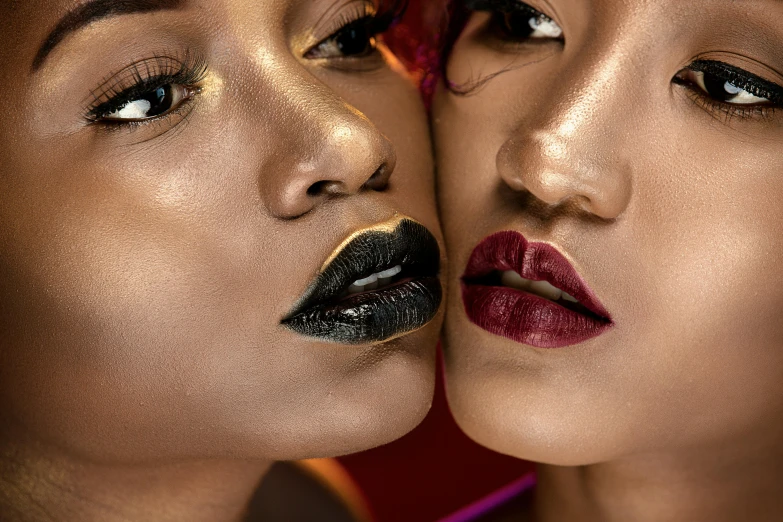 two models with bright makeup and red lipstick