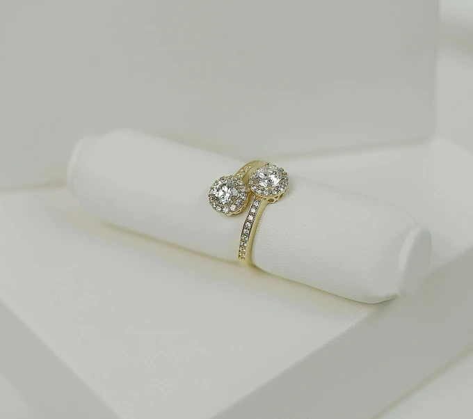 an engagement ring with a three stone setting on a napkin