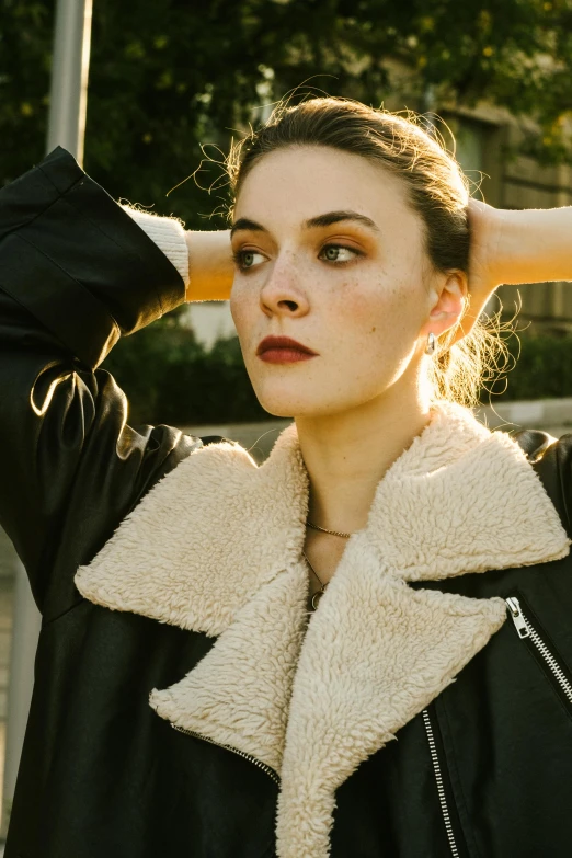 a close up of a person wearing a jacket and a black coat