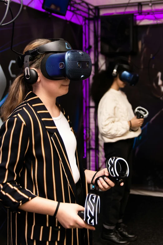 two young women using virtual headsets to study what is happening