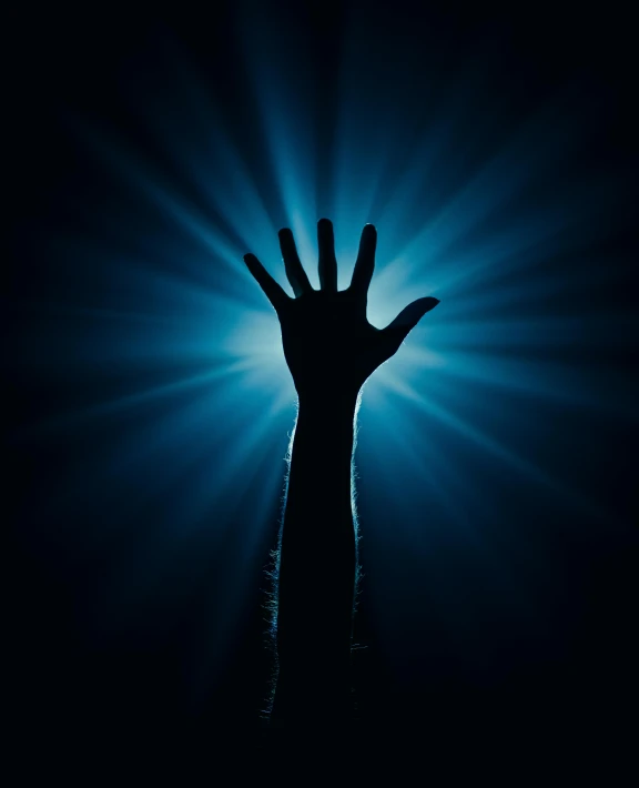 a hand is illuminated by a black light