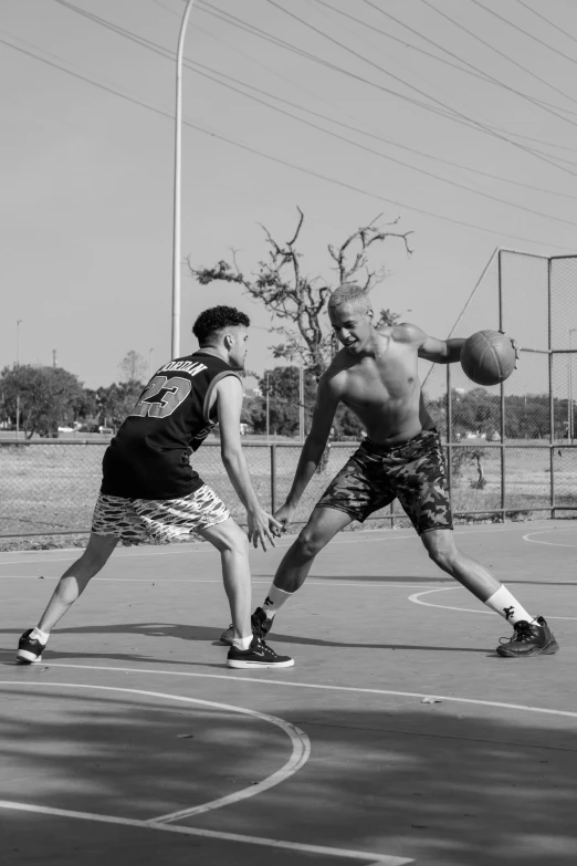 two men are playing basketball on a court