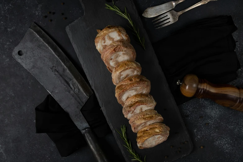 a large loaf of meat is on a  board