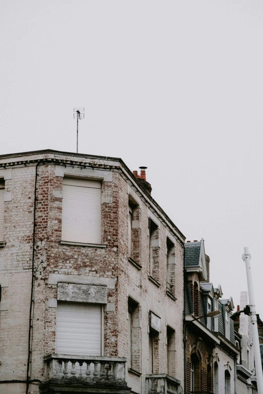 a very tall brick building next to other buildings