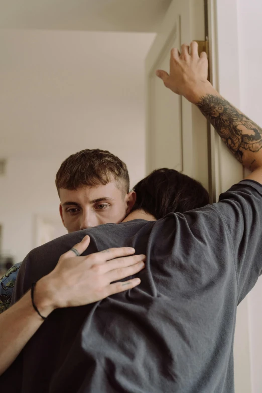 a man and a woman emcing in front of a door