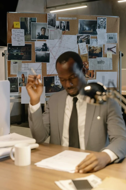 a businessman is smoking at a desk in his office