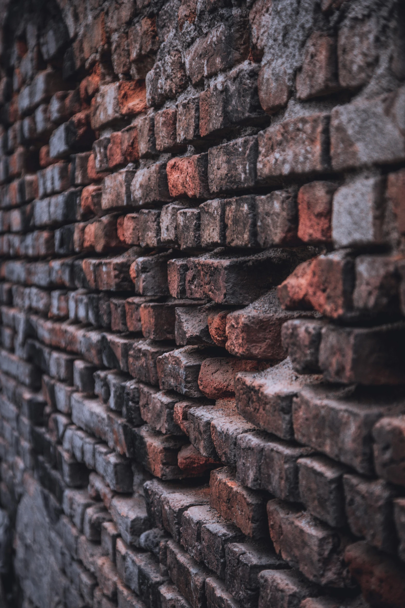 bricked wall that is closeup with the stone ing off