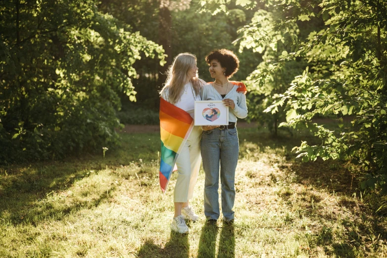 a couple of young people walking across a lush green field