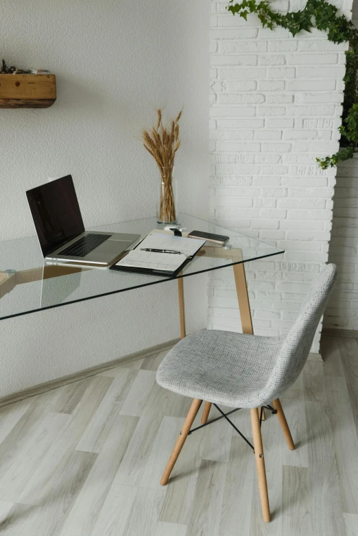 a desk with a laptop sitting on top of it