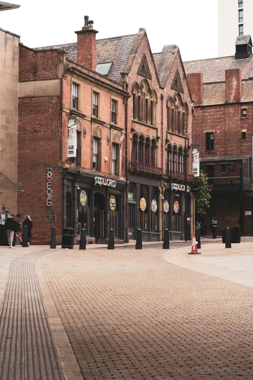 a brick street with many stores on it