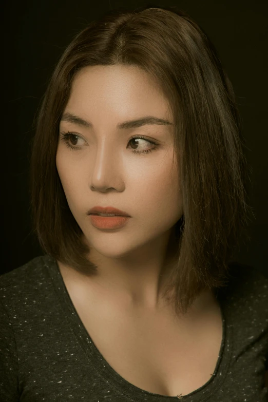 a close - up of a woman with short hair and bangs