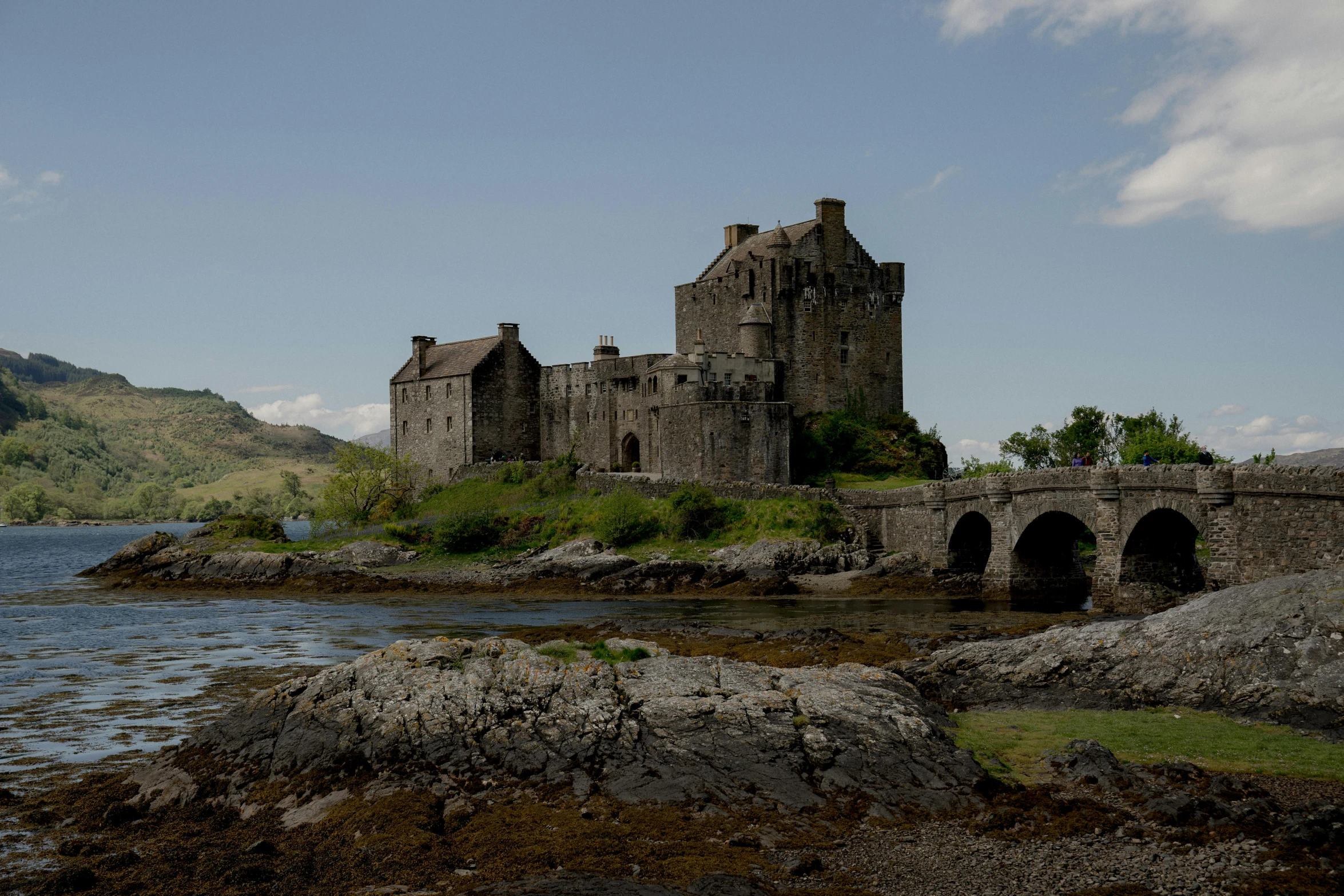 an old castle sitting on a small island near a river