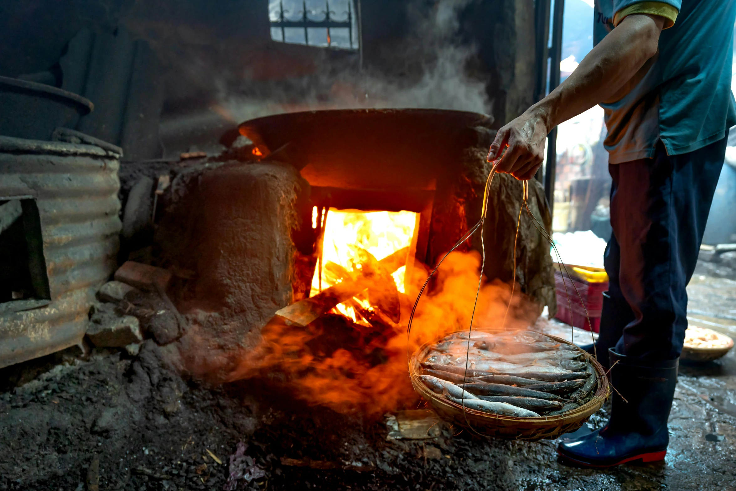 a person standing next to a stove on fire