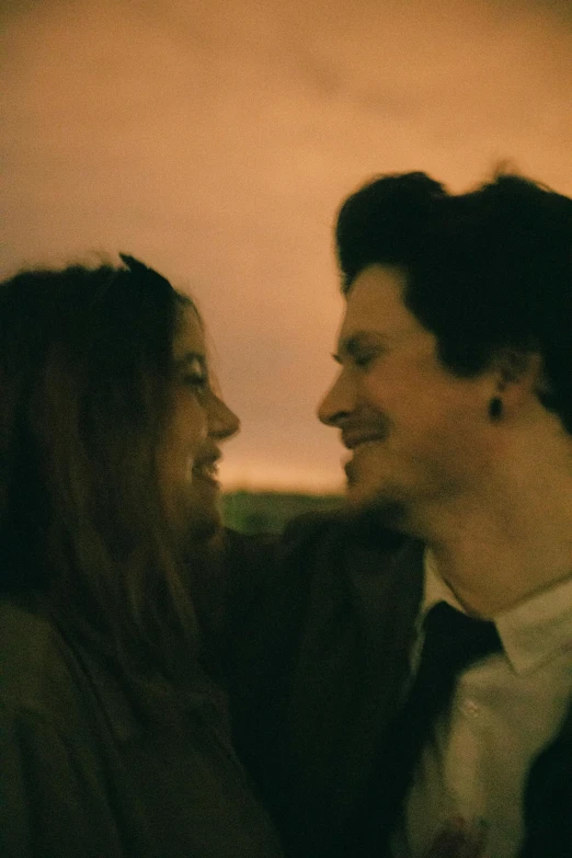 two people sitting at a bar in an old pub looking at each other