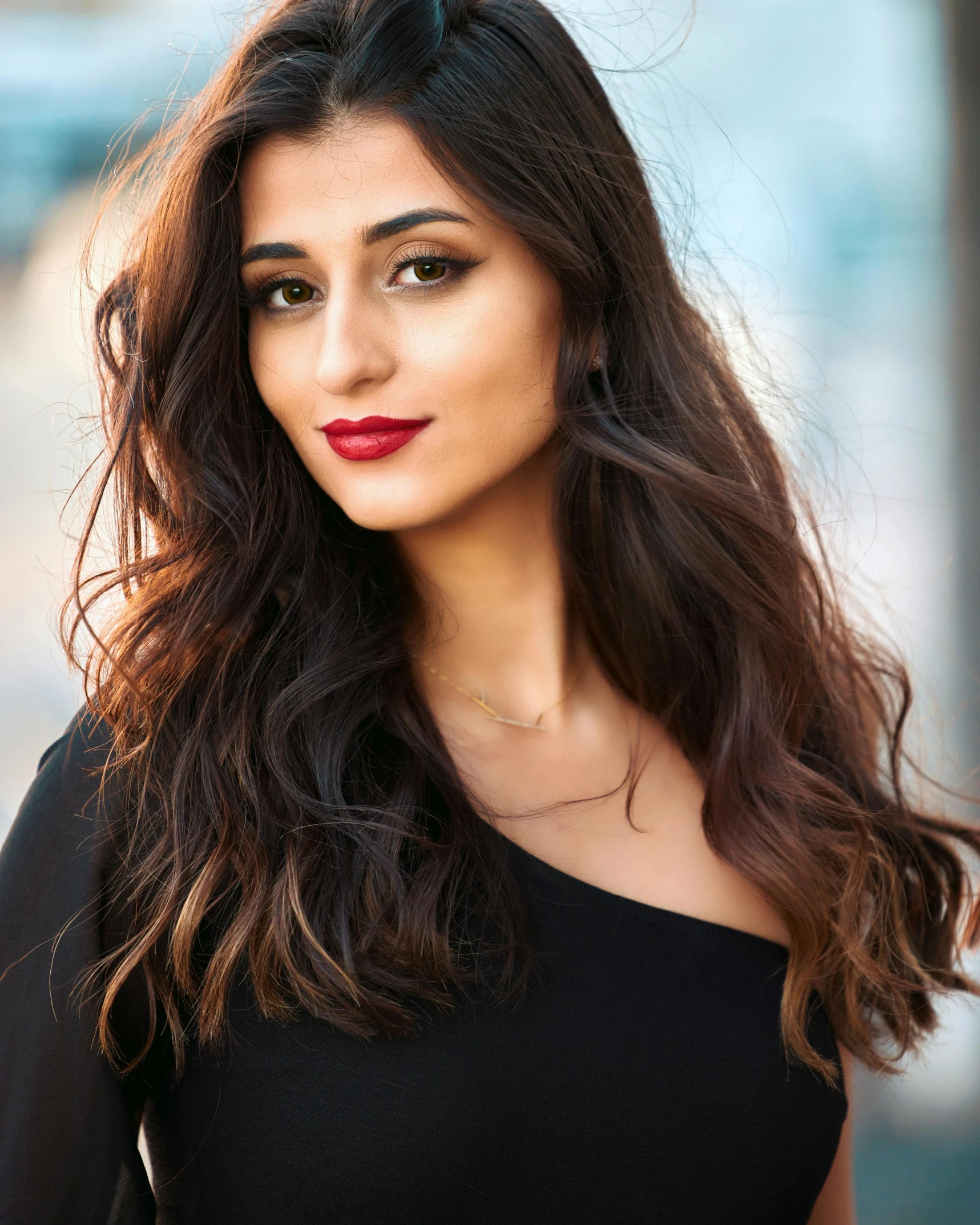 woman with long wavy hair wearing red lipstick