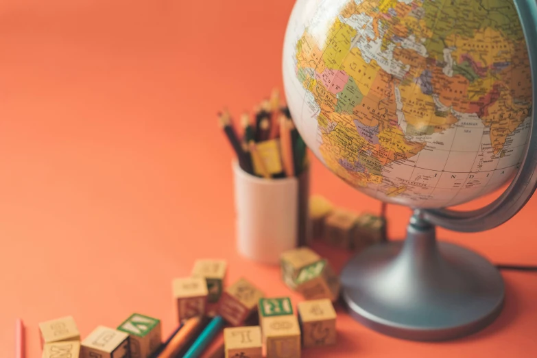 some letters and a small globe sitting on a table