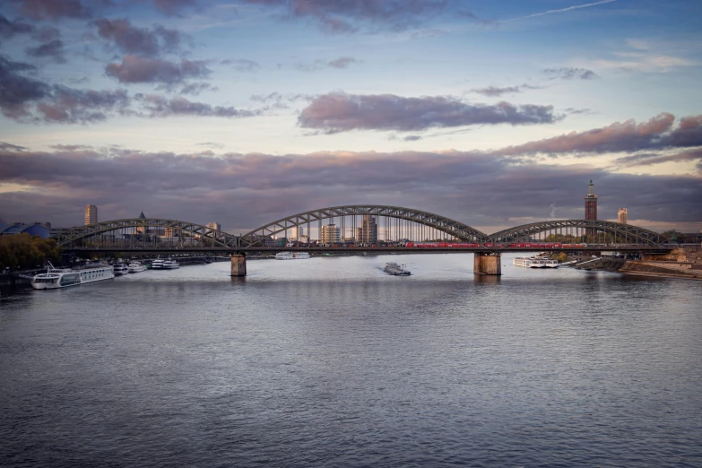 a bridge spanning across a river and the sky is lit