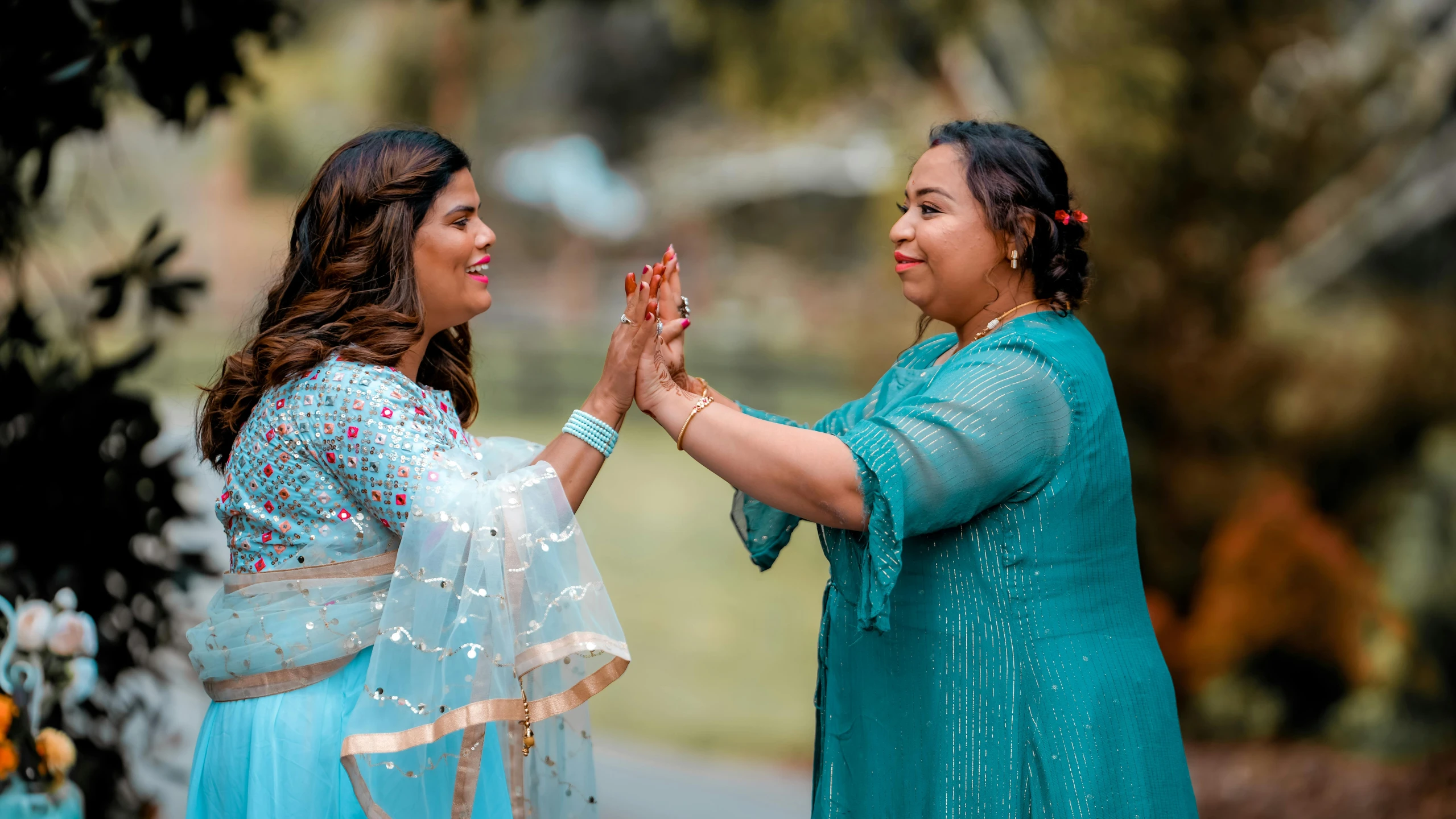 two brides with their hands holding each other