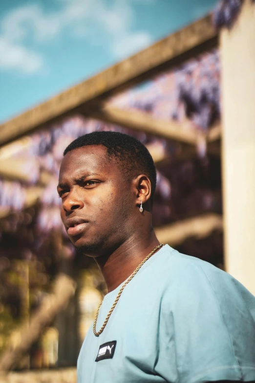 a man is standing in front of a wall and a fence