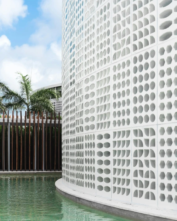 a white building near a green pool