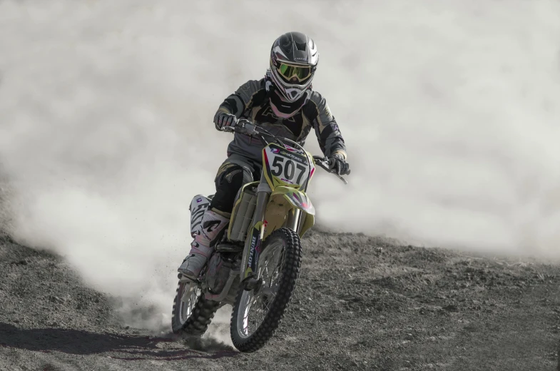 a person riding a motorcycle on a dirt road