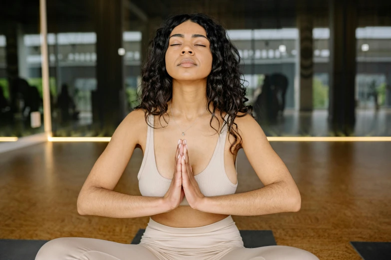 a woman sits in the middle of a yoga class