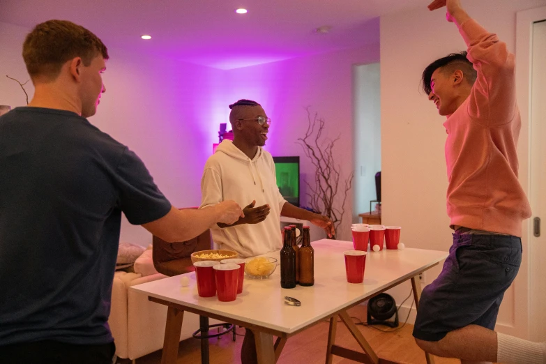 two men are playing a video game at a party