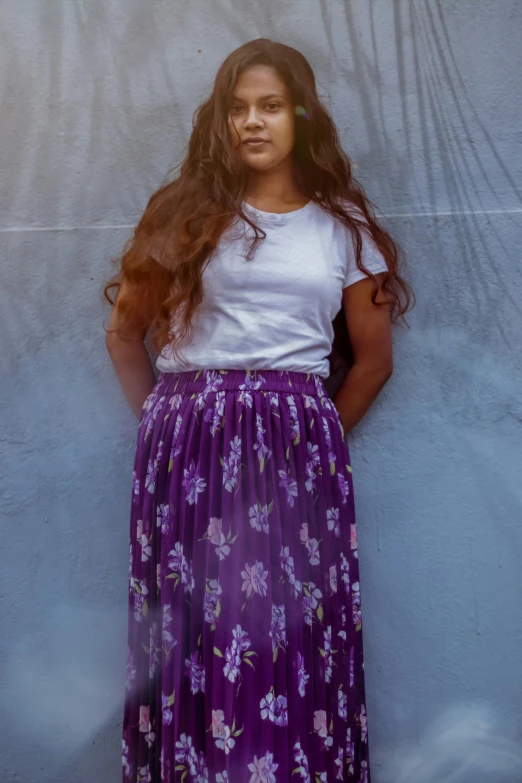 a woman standing in front of a wall