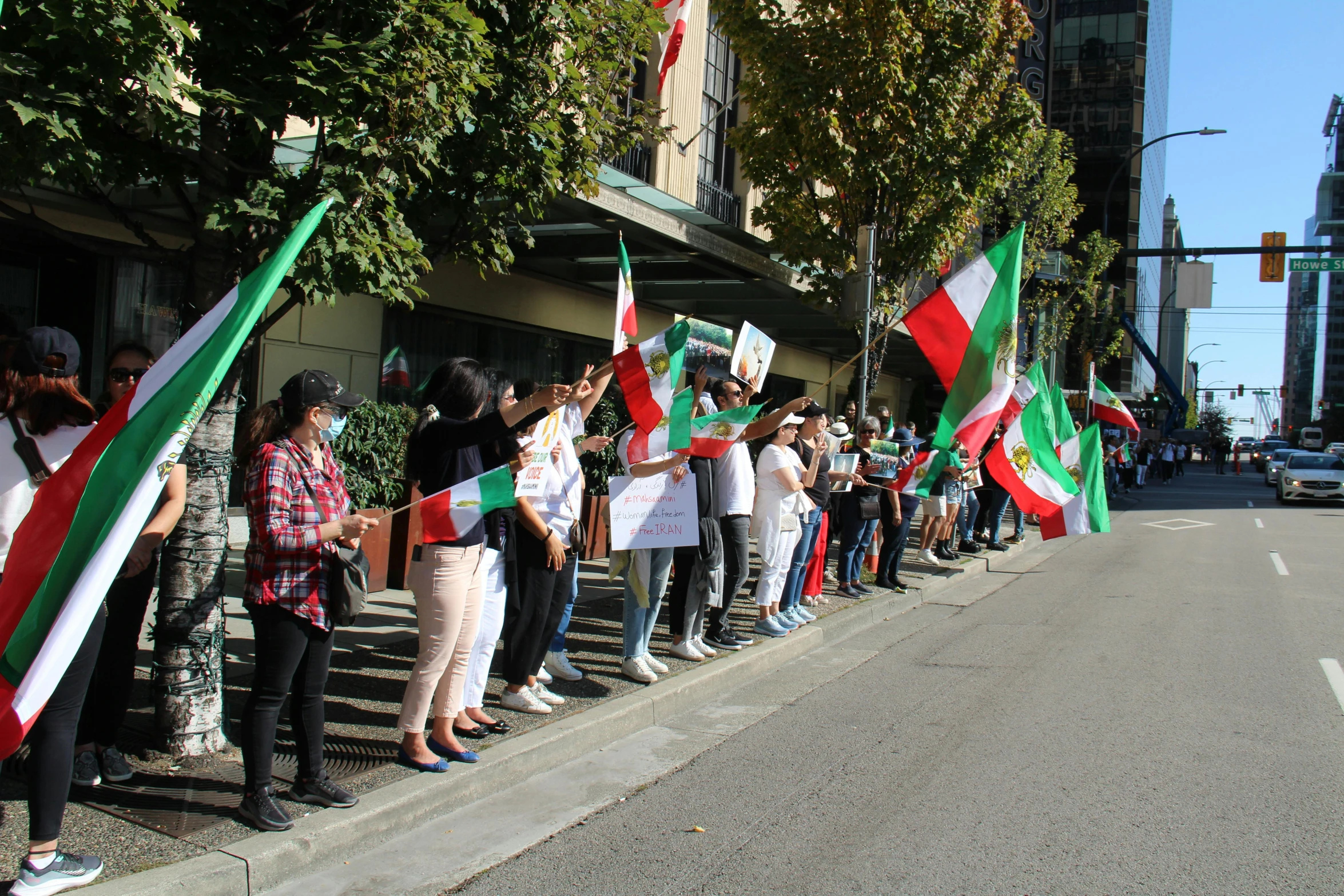 group of people protesting while onlookers watch