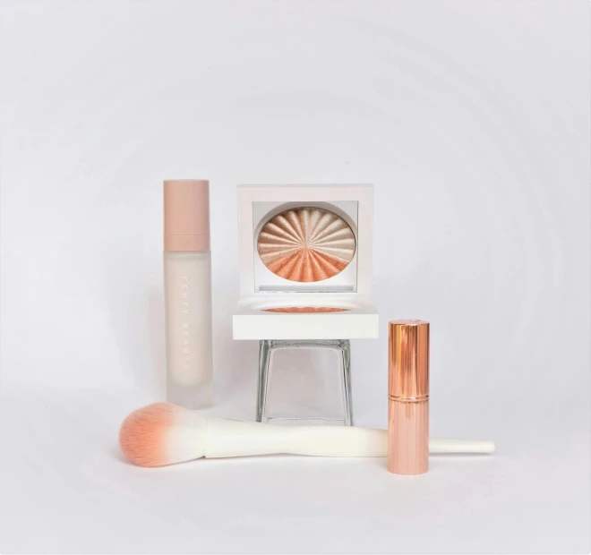 a white surface with makeup items sitting on it