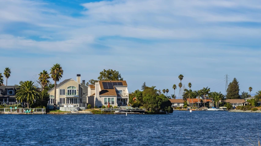 an island in the middle of a lake near houses